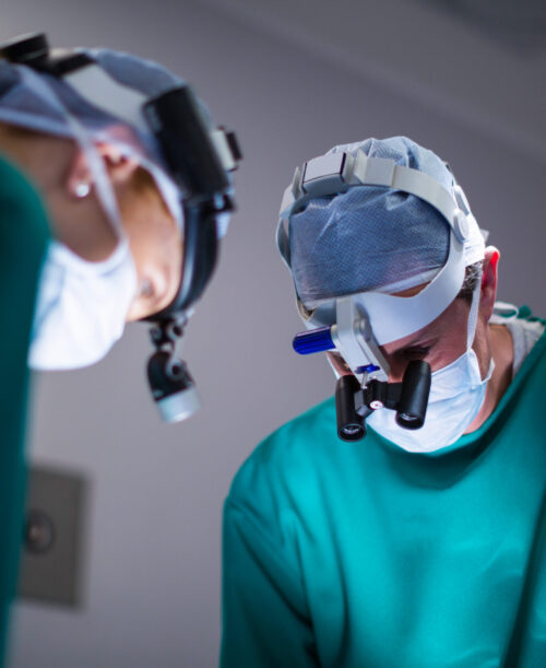 Surgeons wearing surgical loupes while performing operation in operation theater